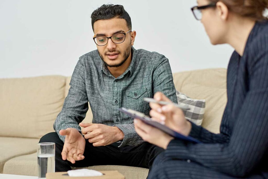 man talks with therapist about can depression be treated