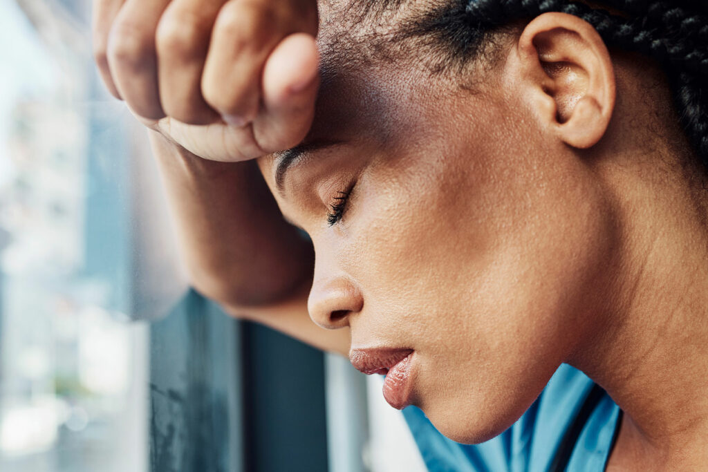 woman leans against window and considers ways to fight depression