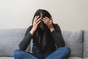 woman with head in hands wonders if depression is a disability