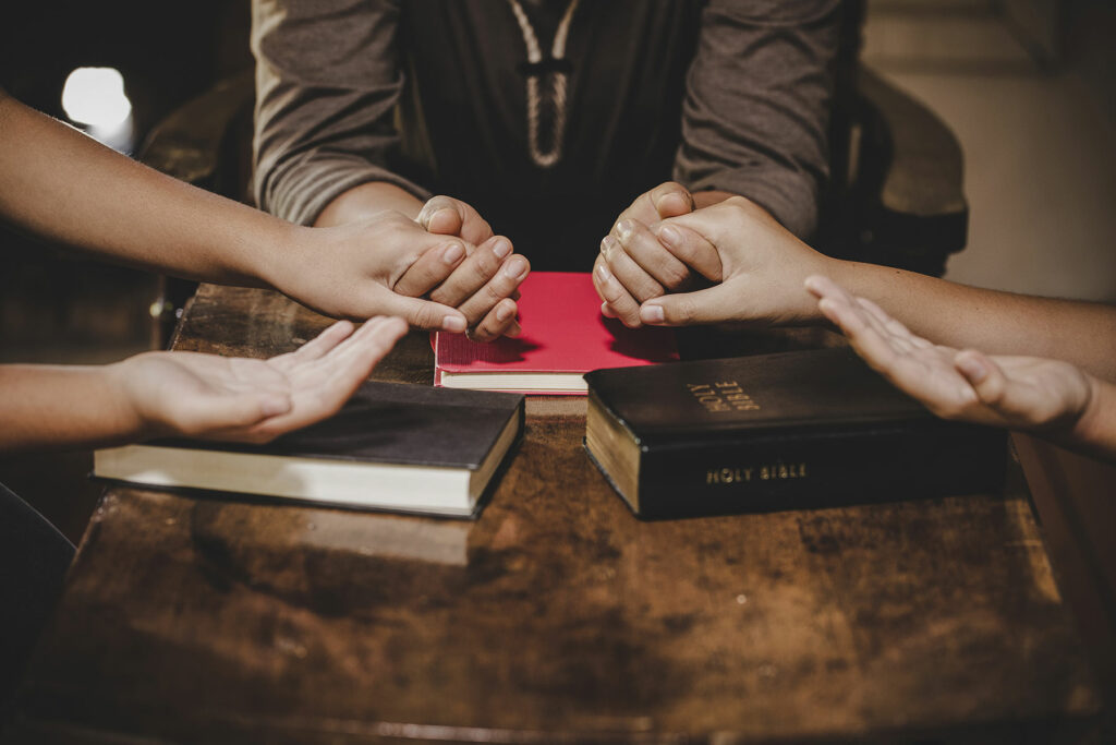 Hands of two people experiencing Christian counseling benefits