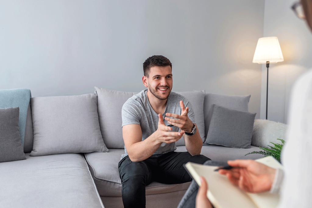 a person talks to a therapist while sitting on a couch and asking what is dual diagnosis treatment