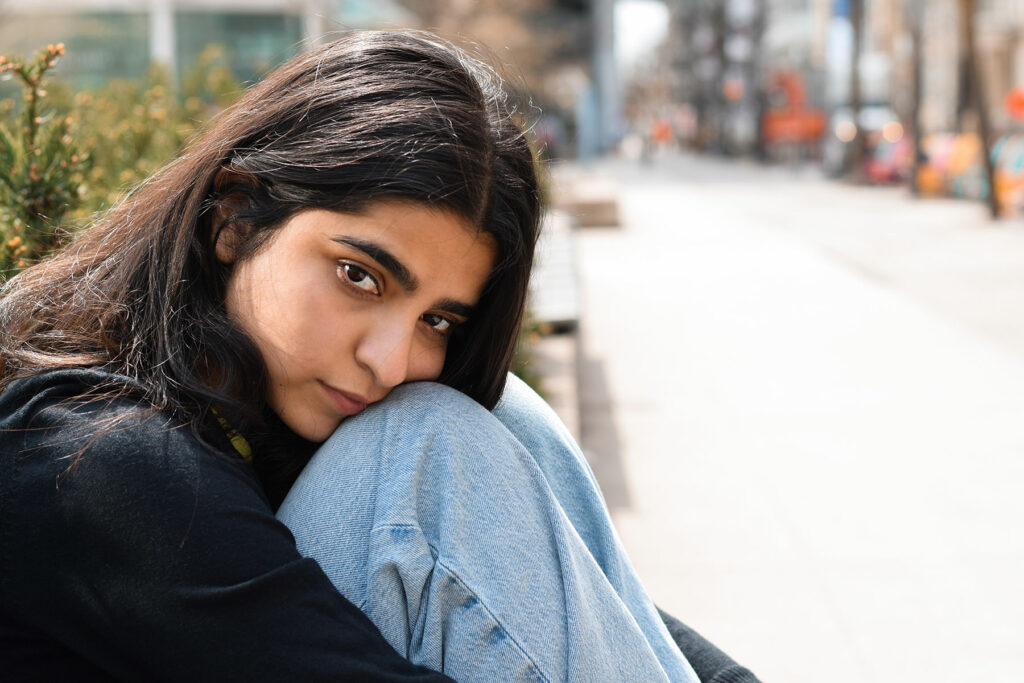 a teen looks at the camera wondering how do I know if my teenager has a mental illness