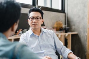 man in glasses talks with therapist about what is mood disorder treatment