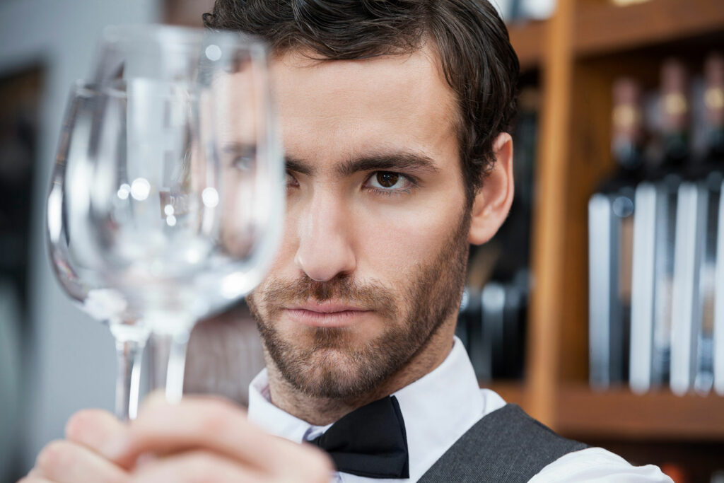 Man looking at wine glass and wondering, "Is alcohol poisoning deadly?"