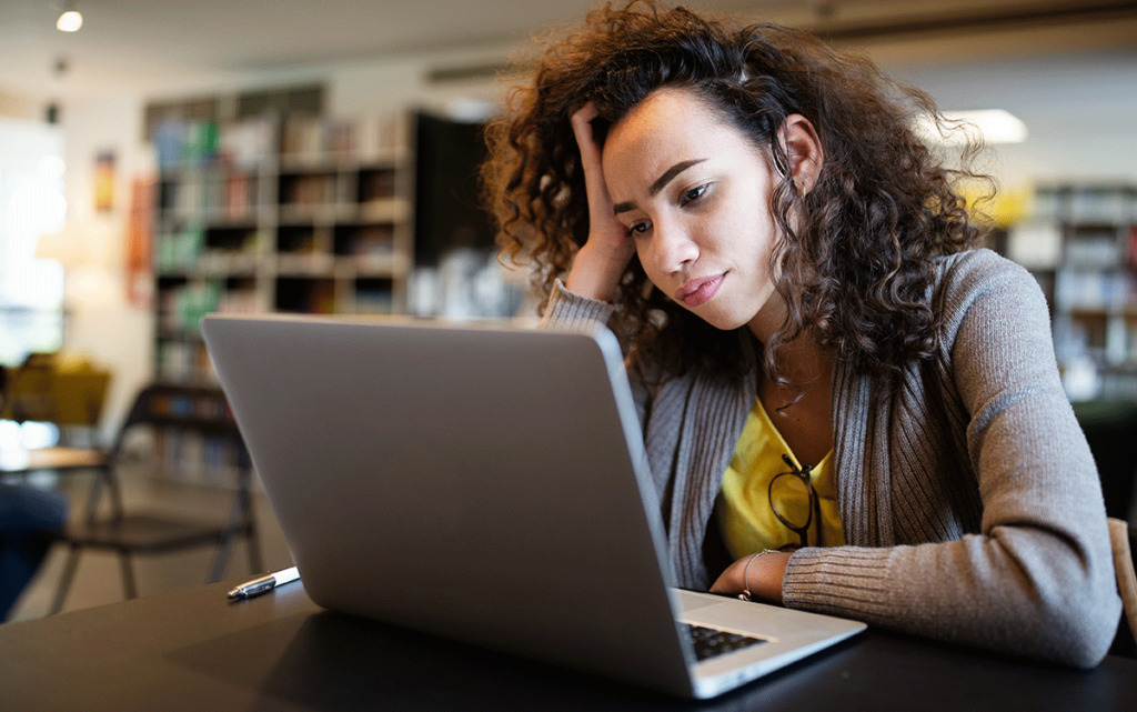 a person looks at a computer screen wondering about adhd symptoms in adults