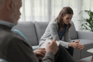 woman on couch talks with therapist about starting a christian depression treatment program