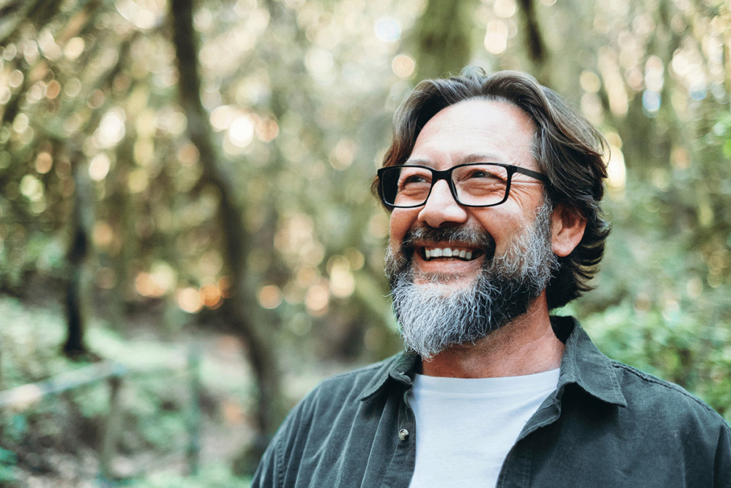 man smiles while thinking about the future of his life after addiction