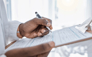 doctor writes on clipboard about united healthcare mental health coverage