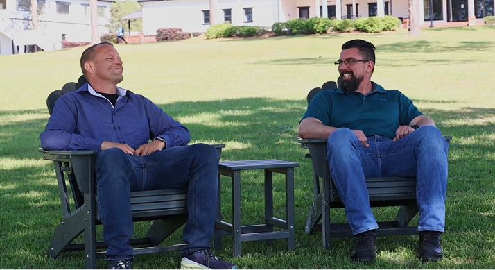 Two adults enjoying a healthy conversation on the green campus of Honey Lake Clinic